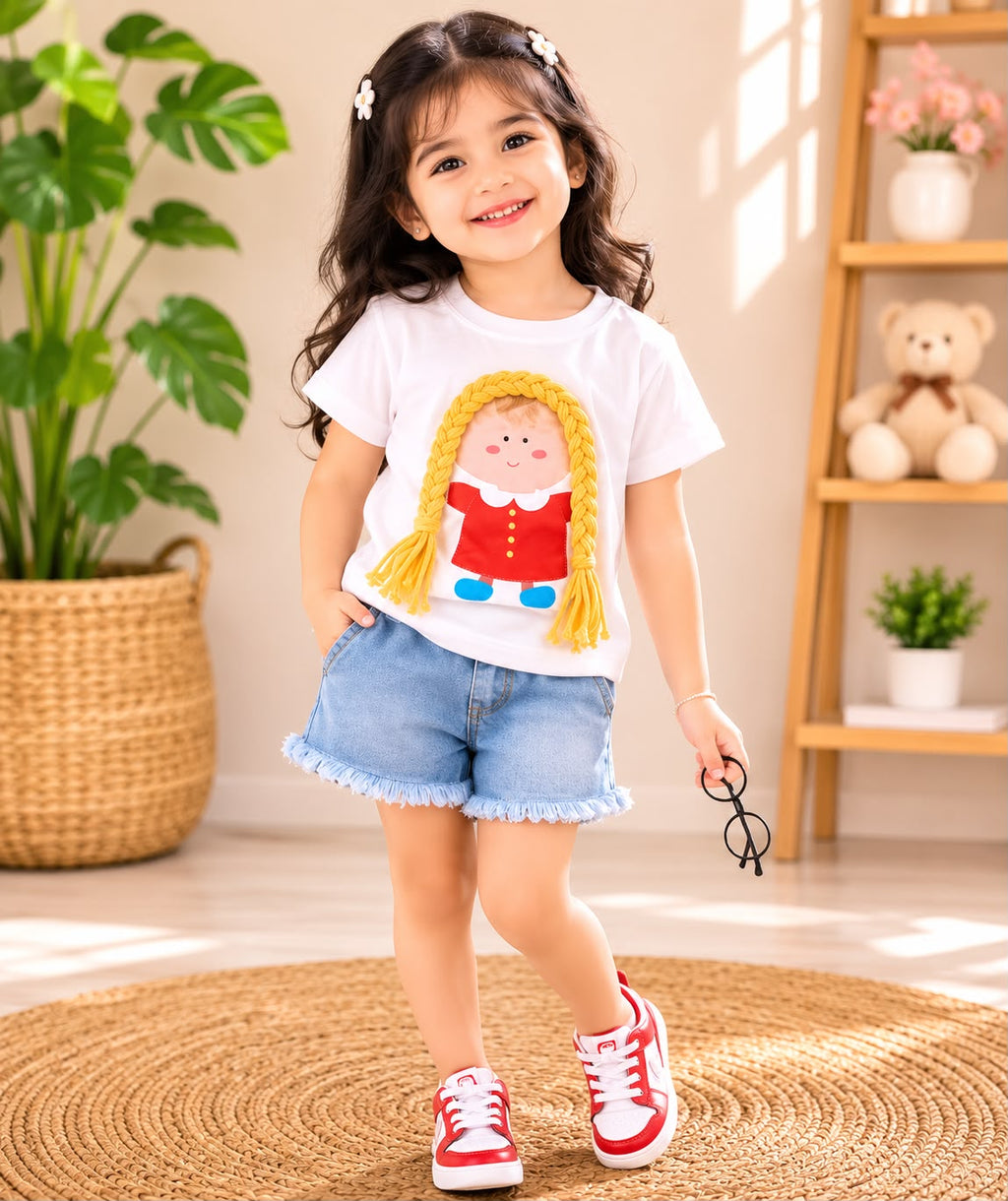 Girl wearing doll print t-shirt and denim shorts