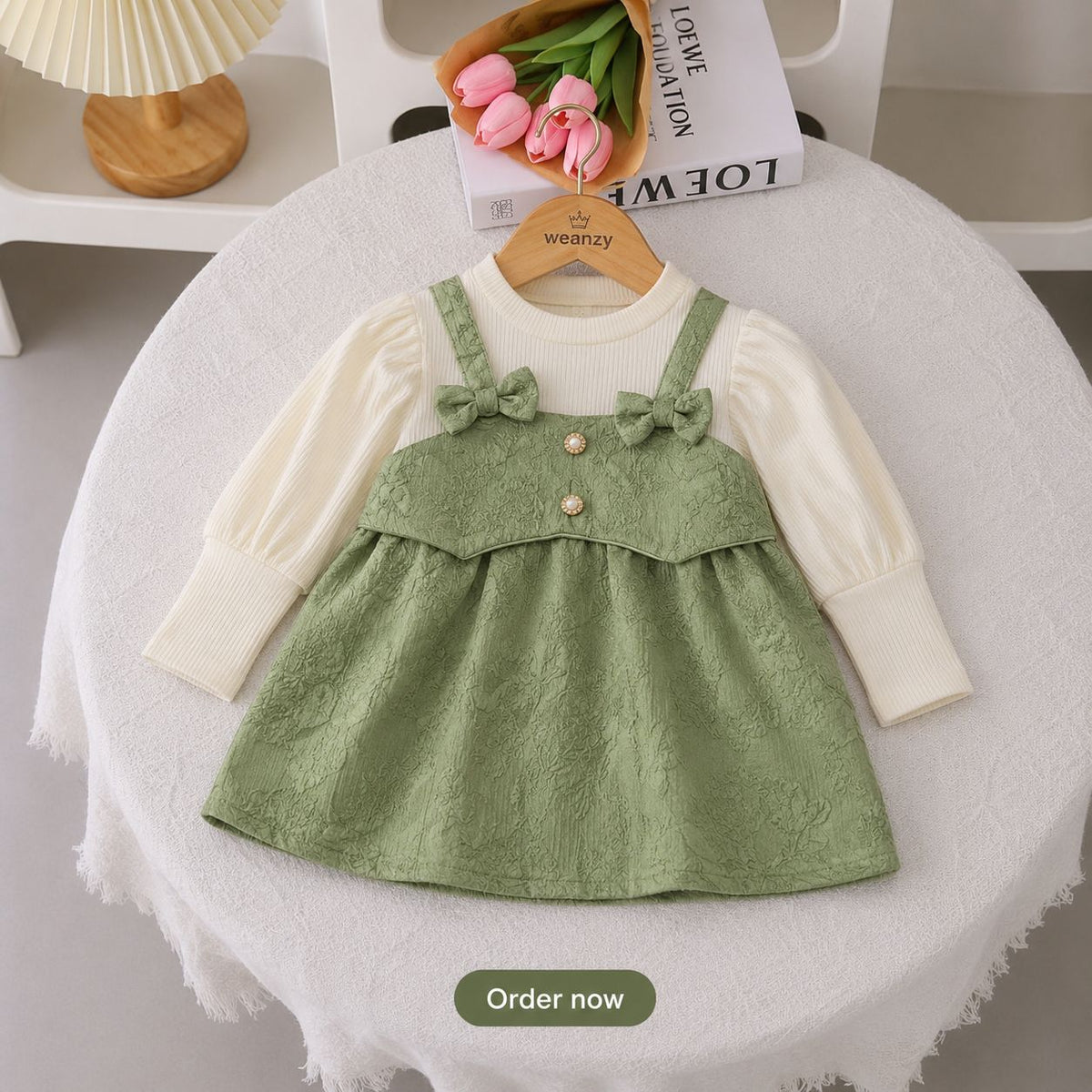 Girl wearing bow suspender dress set with full sleeve top