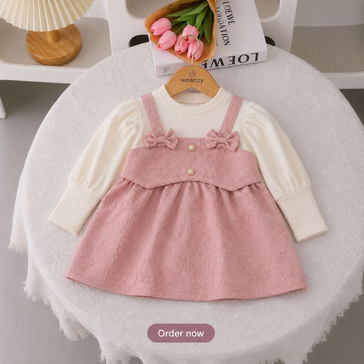 Girl wearing pink bow suspender dress set with full sleeve top